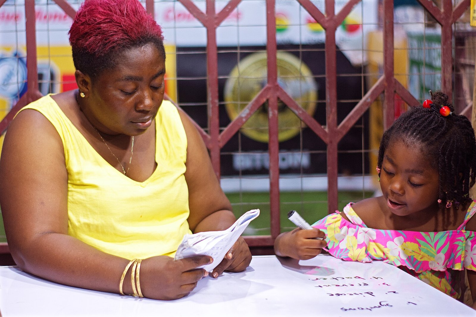 Child doing homework with help from a tutor